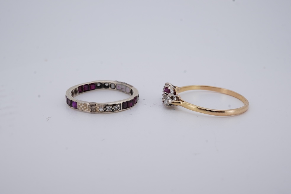A yellow metal, stamped 18ct, ruby and diamond set three stone ring, size W, together with a yellow metal ruby and diamond set full eternity ring, size Q, gross weight 4.4 grams. Condition - poor to fair